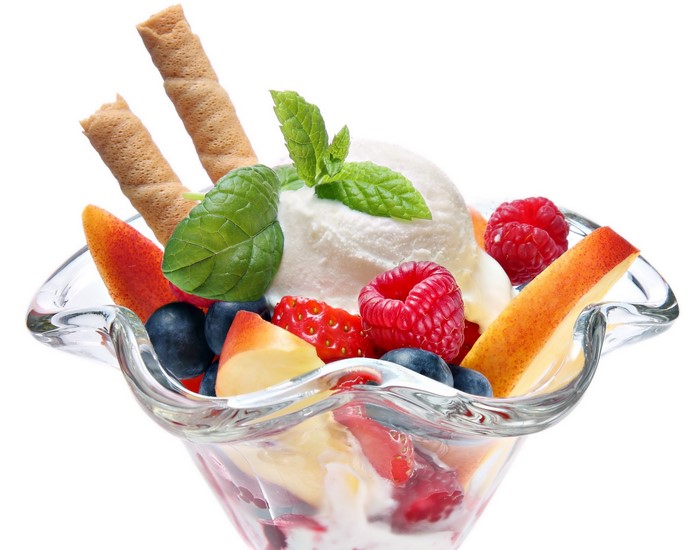 Ice cream sundae with berries and wafer sticks
