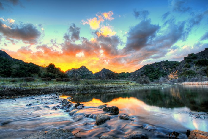 Sunset over mountains and river in Malibu, California