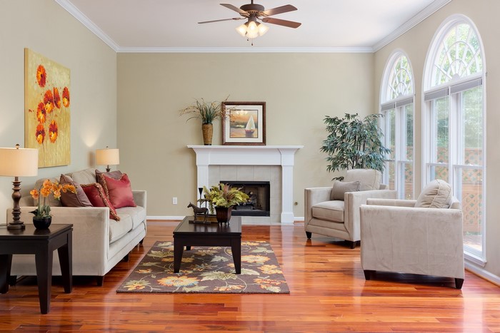 Living room with fireplace, sofa, and armchairs