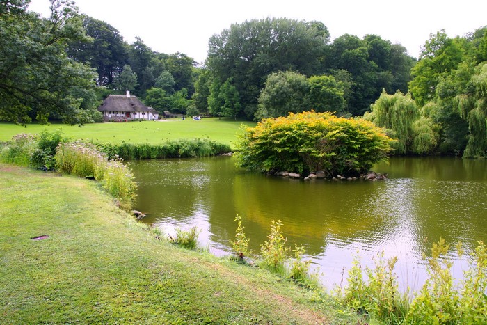 Liselund Park with pond and thatched house