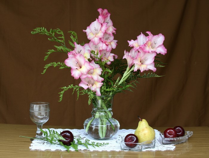 Still life with gladioluses, fruit, and a glass