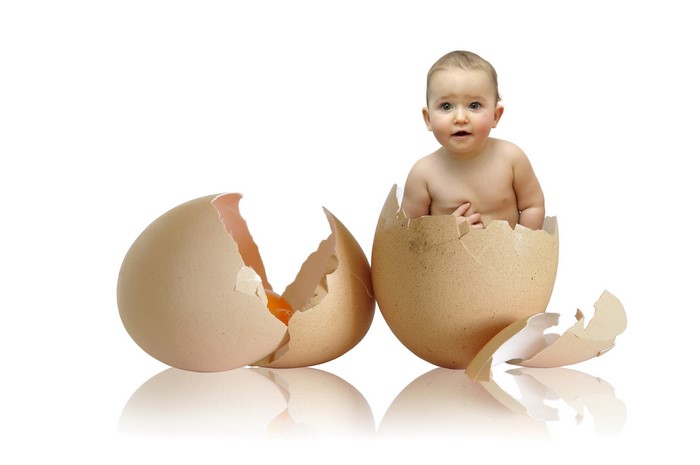 Baby emerging from a cracked egg