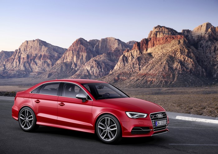 Red 2013 Audi S3 Sedan parked with mountains in background