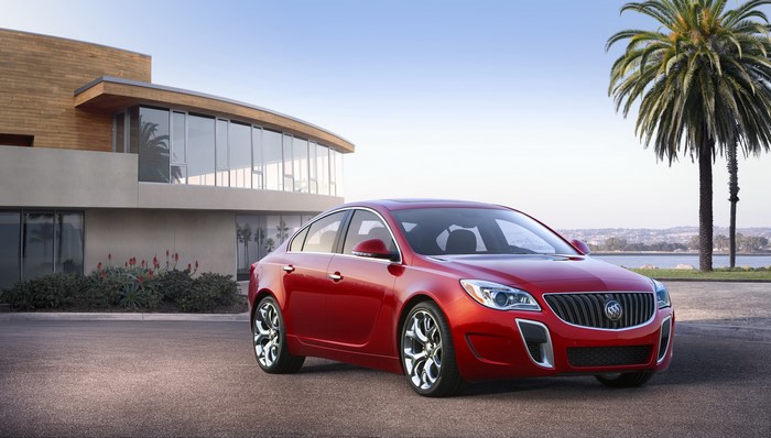 Red 2013 Buick Regal GS parked by a modern house