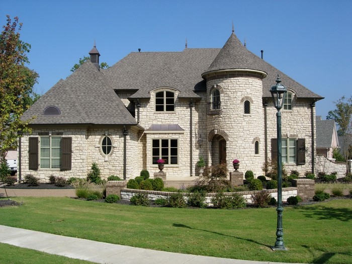 Stone mansion with turrets and arched windows