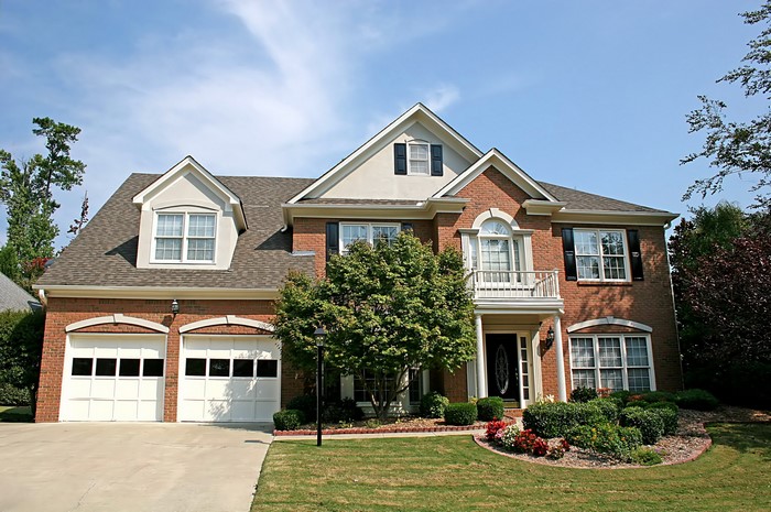 Brick house with garage and balcony