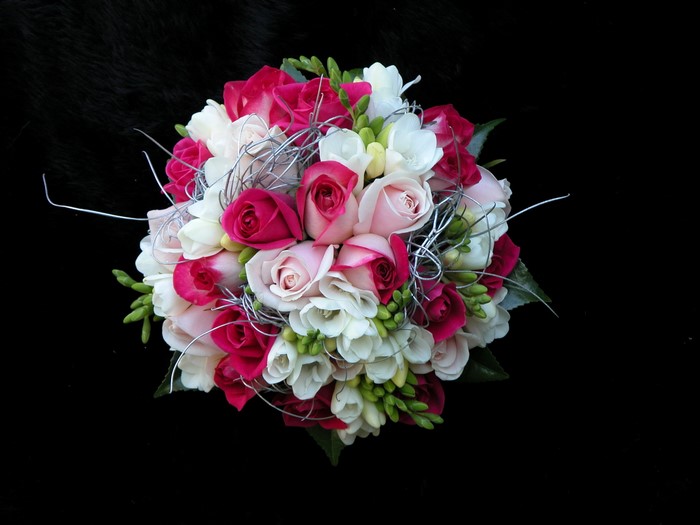 Bouquet of pink, white, and fuchsia roses with silver accents