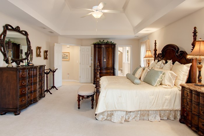 Luxurious bedroom with a large bed and dresser