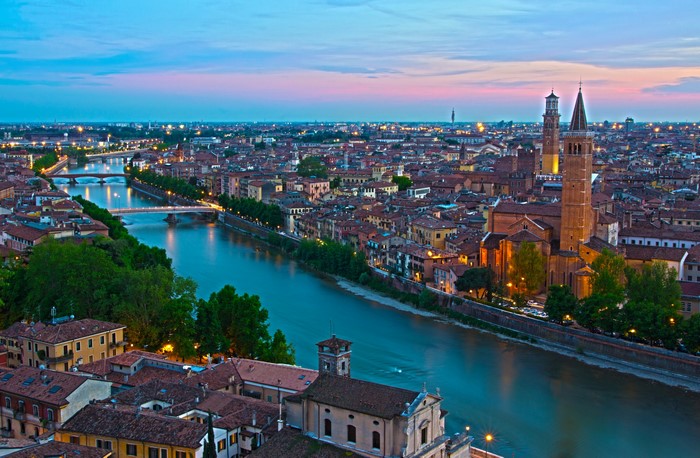 Verona cityscape with Adige River and bridges at dusk