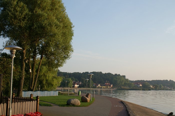 Lakeside promenade with trees and houses in Lithuania