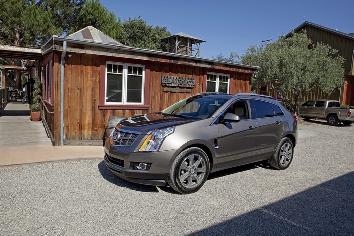 2012 Cadillac SRX in front of a wooden building