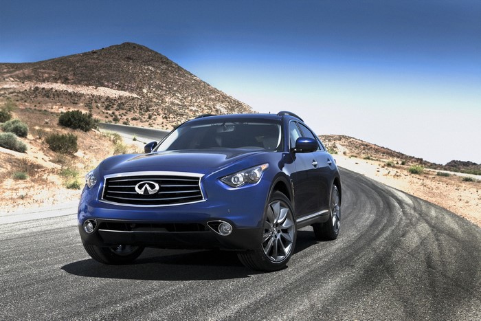 Blue Infiniti FX35 driving on a desert road