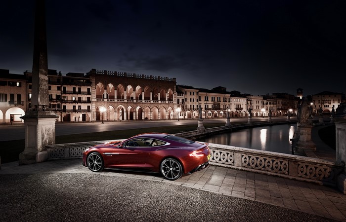 Aston Martin Vanquish parked by a canal at night