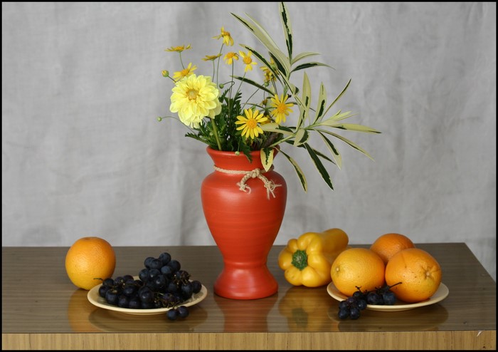 Still-life with flowers in a vase and fruits