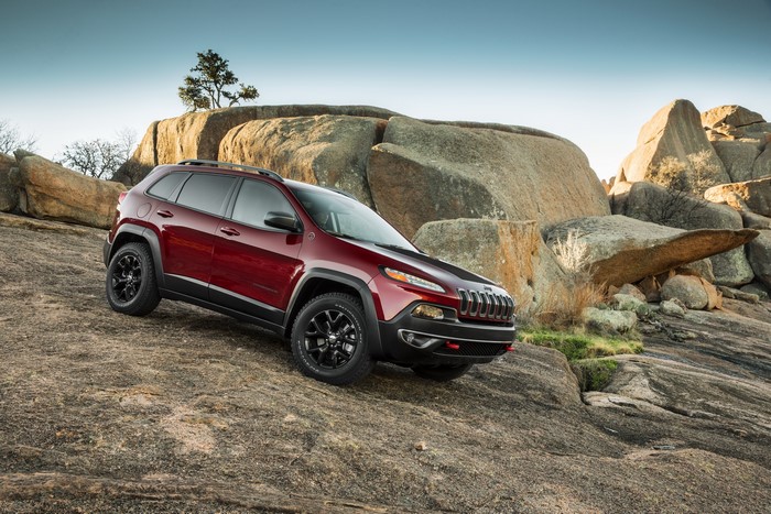 Red Jeep Cherokee Trailhawk on rocky terrain