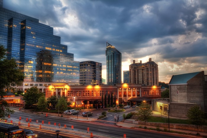 Cityscape with modern buildings and street at dusk