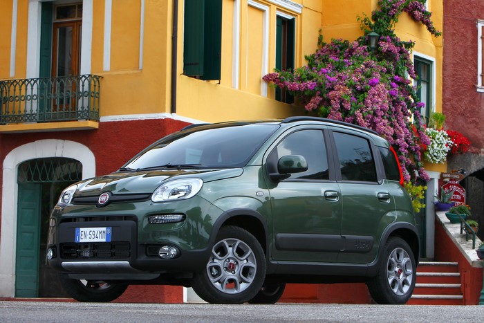 Green Fiat Panda 4x4 parked in front of a colorful building