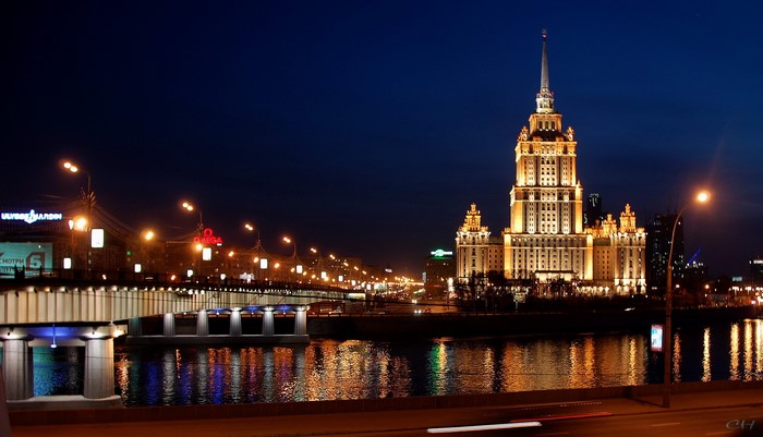 Moscow skyline with illuminated bridge and skyscraper at night