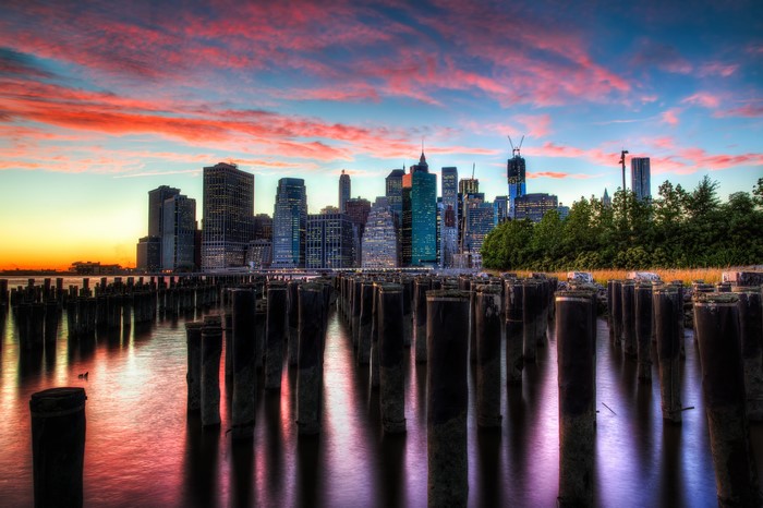 New York City skyline at sunset with wooden pilings