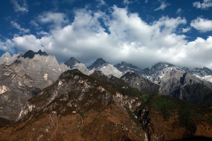Yulong Snow Mountains in Lijiang, China under a cloudy sky
