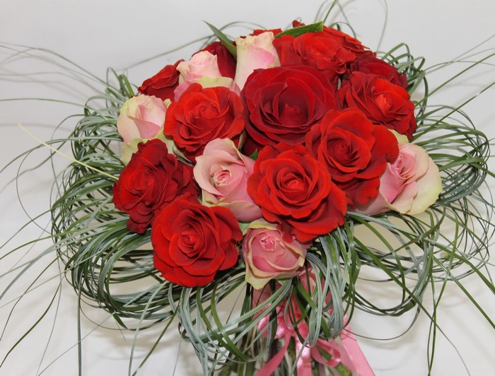 Bouquet of red and pink roses with greenery