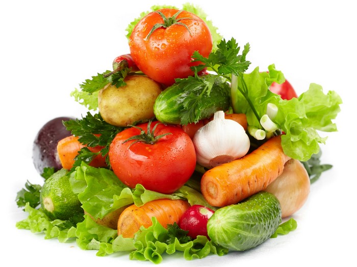 Pile of fresh vegetables including tomatoes, carrots, and lettuce