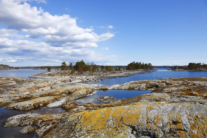 Rocky islands and blue water under a cloudy sky