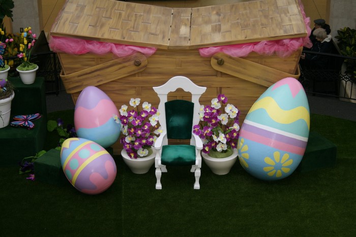 Easter eggs and chair in front of a picnic basket