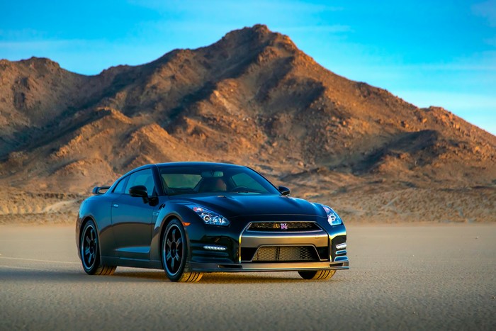 Black Nissan GT-R R35 in desert landscape with mountains