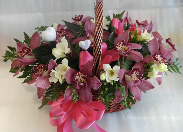 Orchid bouquet in a wicker basket with hearts