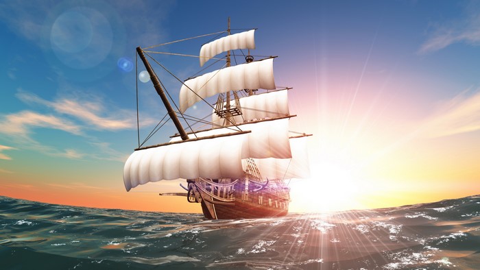 Sailing ship on the sea at sunset