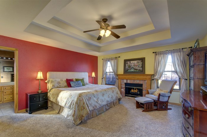 Bedroom with Fireplace and Tray Ceiling
