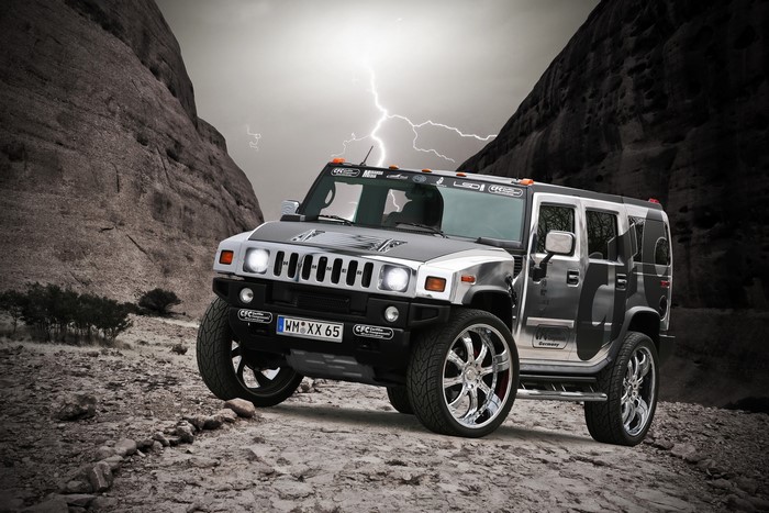 Silver Hummer H2 on Rocky Terrain with Lightning