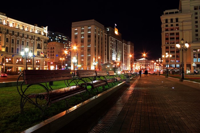 Moscow street at night with benches and buildings
