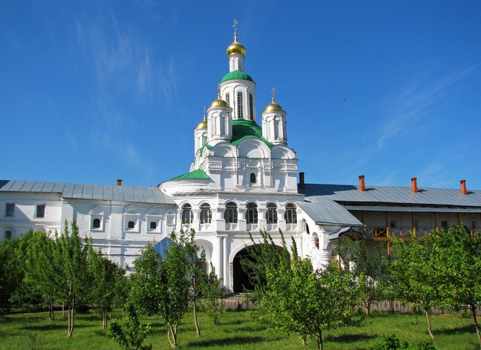 White Orthodox Church with Green and Gold Domes in Russia