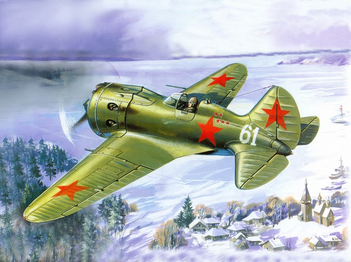 Green biplane with red stars flying over a snowy village