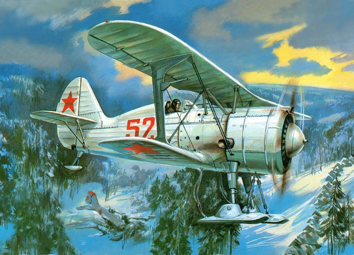 I-15 bis biplane flying over a snowy forest