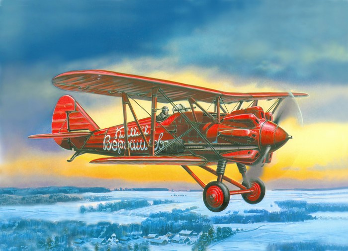 Red Polikarpov I-5 biplane flying over a winter landscape