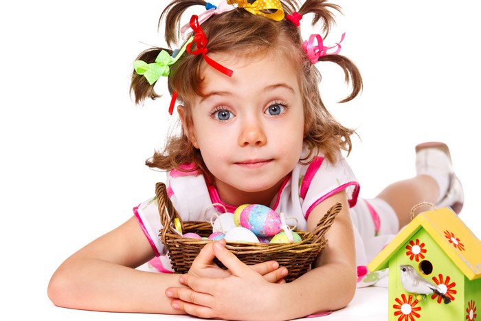 Little girl with Easter eggs and birdhouse