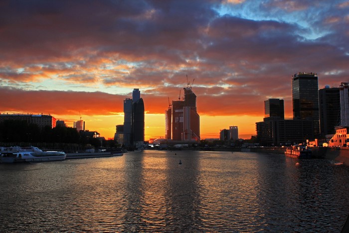 Moscow skyline at sunset with river and clouds