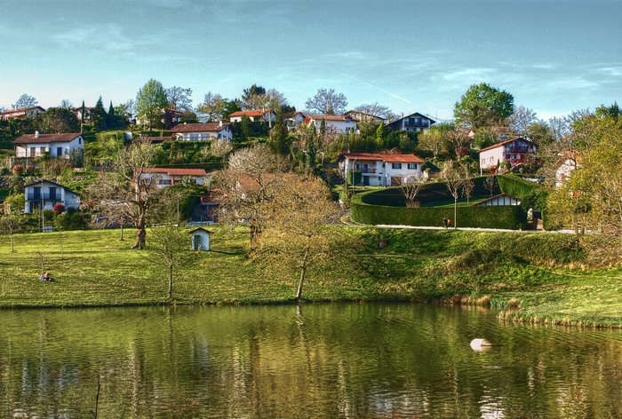 Houses on a hill overlooking a lake in Saint-Pee-sur-Nivelle, France