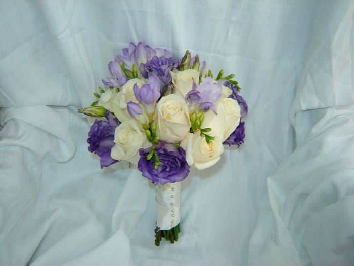 Wedding bouquet with white roses and purple flowers