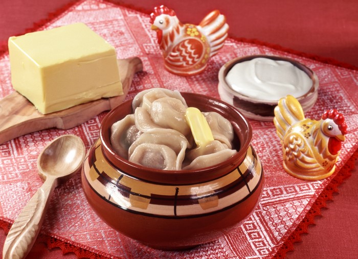 Pelmeni with butter, sour cream, and decorative chickens