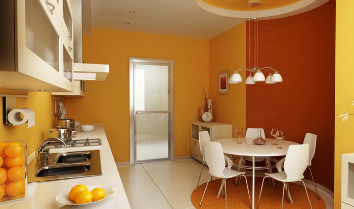 Modern kitchen and dining area with orange walls