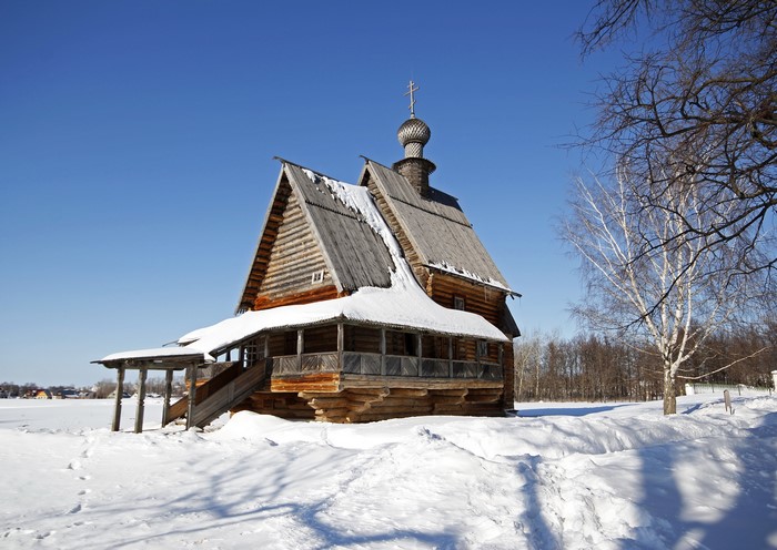 Wooden church in Russia during winter with snow