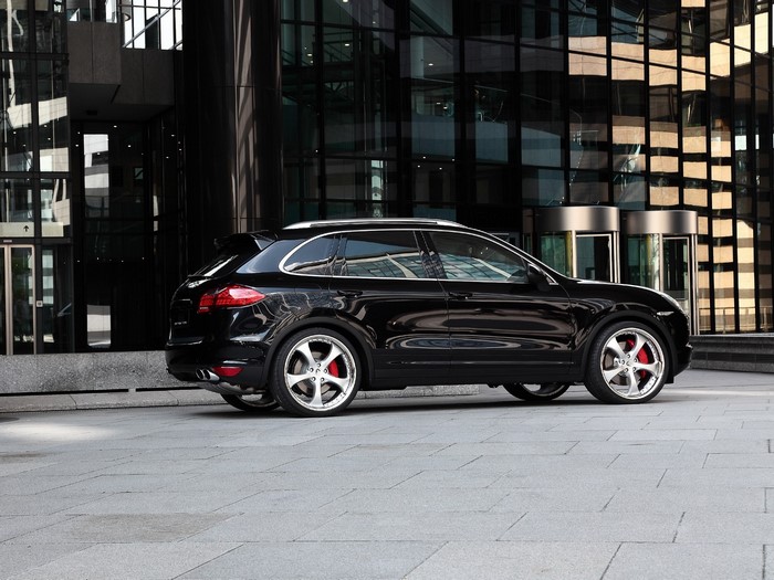 Black Porsche Cayenne parked outside modern building