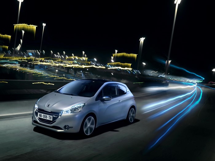 Peugeot 208 driving at night with light trails