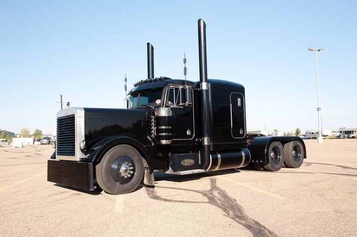 Black Peterbilt Semi-Truck parked in a lot