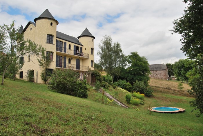 Yellow castle-like house with a pool in France