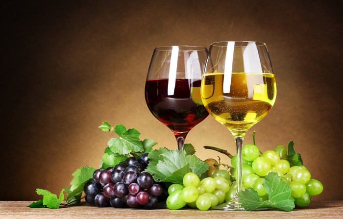 Still-life of red and white wine with grapes
